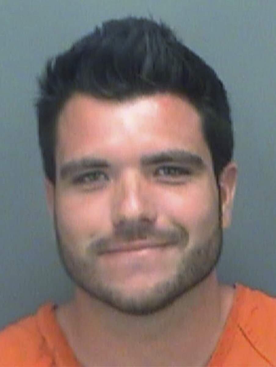 This undated photo made available by the Pinellas County, Fla., Sheriff's Office, shows Michael Wenzel under arrest. Florida wildlife officials and prosecutors have charged three men, Wenzel, Spencer Heintz, and Robert Lee Benec, of Palmetto connected to a video of a shark being dragged behind a speeding boat. Wenzel is charged with two felony counts of aggravated animal cruelty. (Hillsborough County Sheriff's Office via AP)