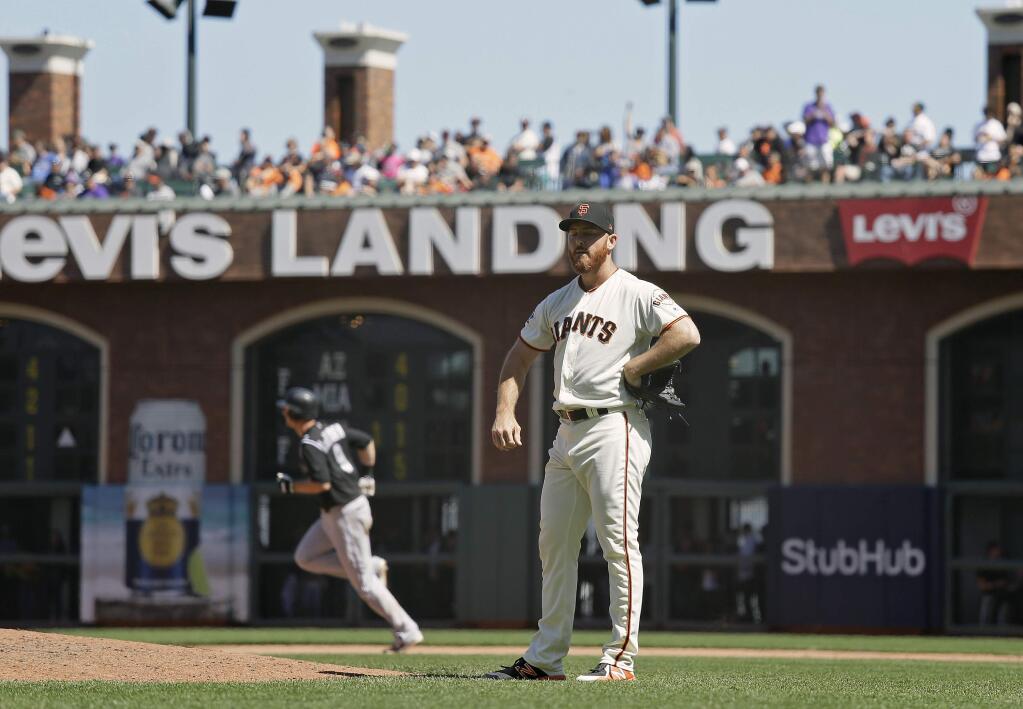 San Francisco Giants relief pitcher Sam Dyson stands on the mound after giving up a two-run home run to the Colorado Rockies' DJ LeMahieu in the ninth inning Thursday, June 28, 2018, in San Francisco. Colorado won the game 9-8. (AP Photo/Eric Risberg)