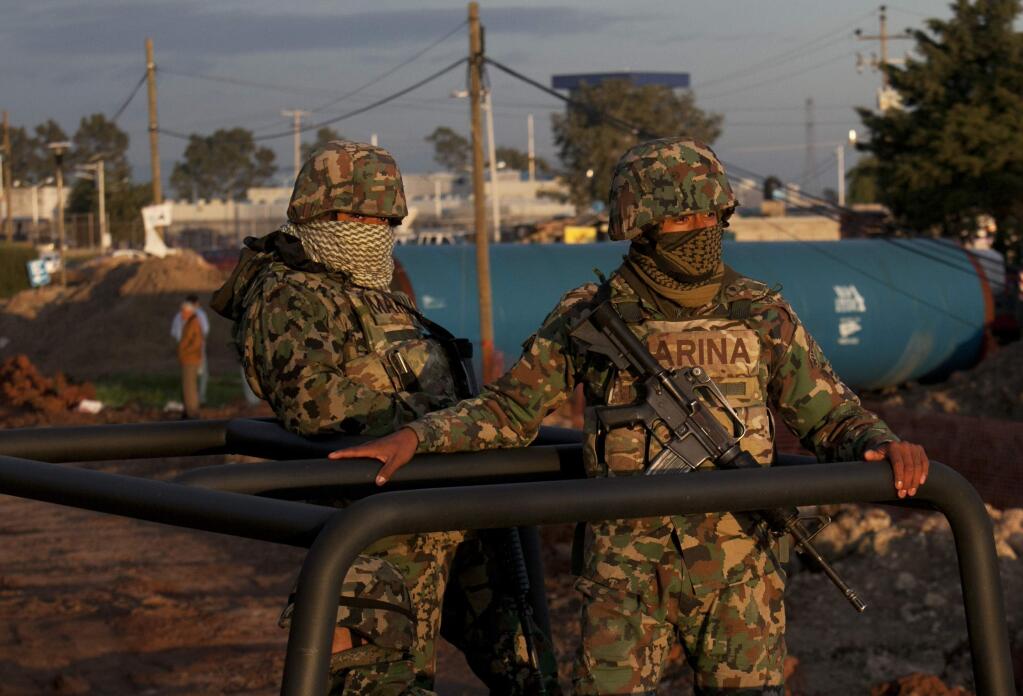 Mexican navy marines patrol near the maximum security prison Altiplano in Almoloya, west of Mexico City, Sunday, July 12, 2015. Mexico's most powerful drug lord, Joaquin 'El Chapo' Guzman, escaped from a maximum security prison through a tunnel that opened into the shower area of his cell, the country's top security official announced. (AP Photo/Marco Ugarte)