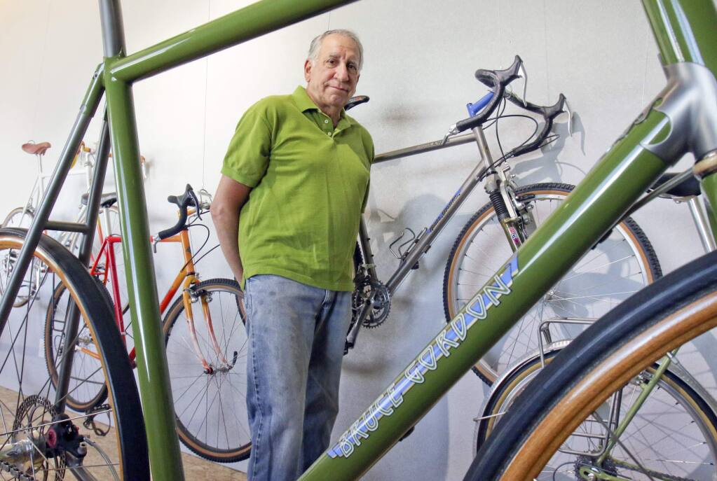Bruce Gordon with some of the bicycles he has built for himself over the years in his Petaluma shop on Tuesday, June 30, 2015. (SCOTT MANCHESTER/ARGUS-COURIER STAFF)