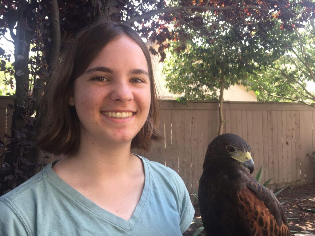 Danielle Dube, 19, a falconer, with her bird, Gambit. ARLINE KLATTE FOR THE ARGUS-COURIER
