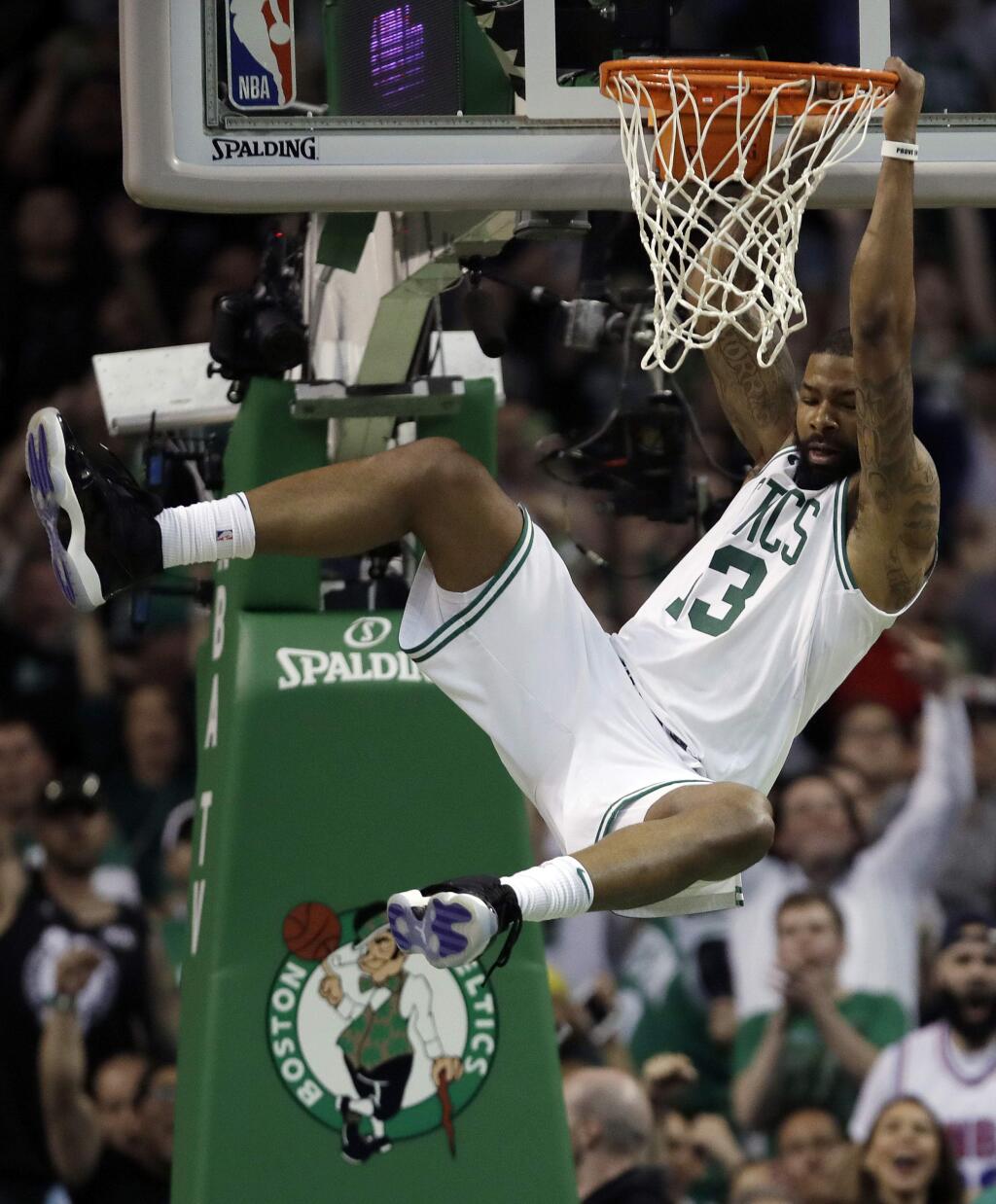 Boston Celtics forward Marcus Morris hangs from the rim after dunking against the Cleveland Cavaliers during the first half in Game 2 of the NBA Eastern Conference final Tuesday, May 15, 2018, in Boston. (AP Photo/Charles Krupa)