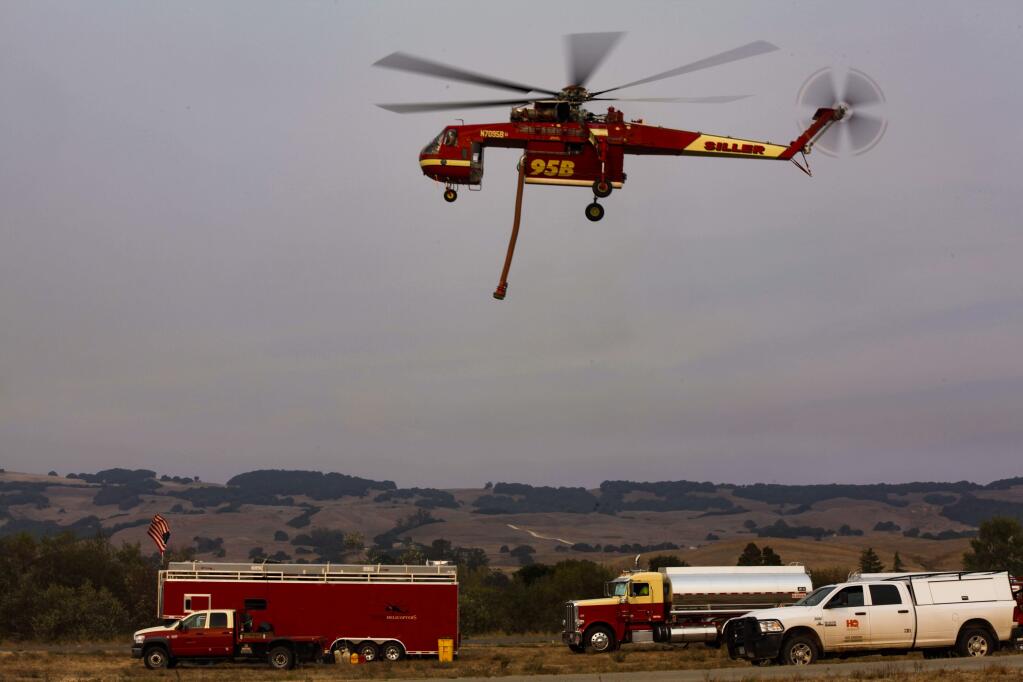 Petaluma, CA. Monday, October 16, 2017._ Helicopters carrying water to quell the wildfires in Santa Rosa and Sonoma take off and land from Petaluma Airport.(CRISSY PASCUAL/ARGUS-COURIER STAFF)