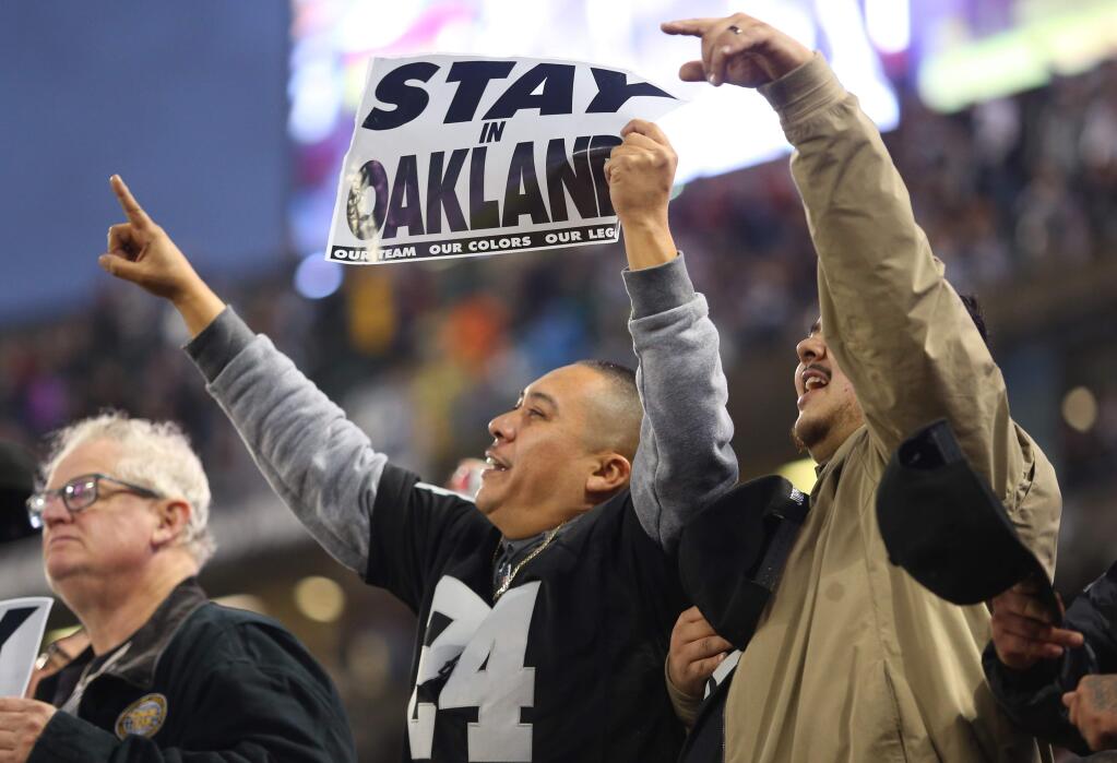 Oakland Raiders fans plead for their team to stay during their game against the Denver Broncos in Oakland on Monday, December 24, 2018. (Christopher Chung/ The Press Democrat)