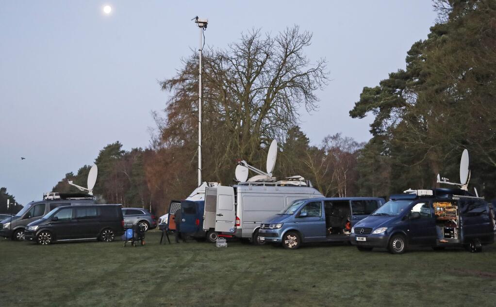 Media prepares in the early morning at the entrance of the castle in Sandringham, England, Monday, Jan. 13, 2020. Prince Harry and his wife Meghan have declared they will 'work to become financially independent' as part of a surprise announcement saying they wish 'to step back' as senior members of the royal family. (AP Photo/Frank Augstein)