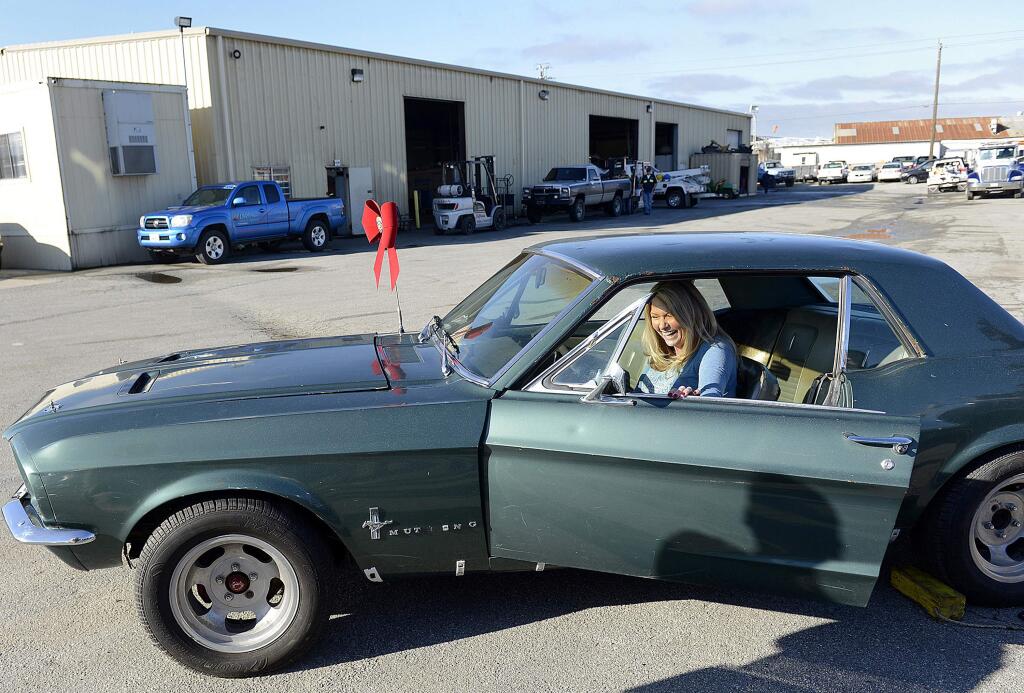 This Dec. 22, 2014 photo shows Lynda Alsip sitting inside her 1967 Ford Mustang at California Towing in Salinas, Calif. The vehicle, Alsip's first car, was stolen from her 28 years ago and was recently recovered by the California Highway Patrol. (AP Photo/Monterey Herald, David Royal)