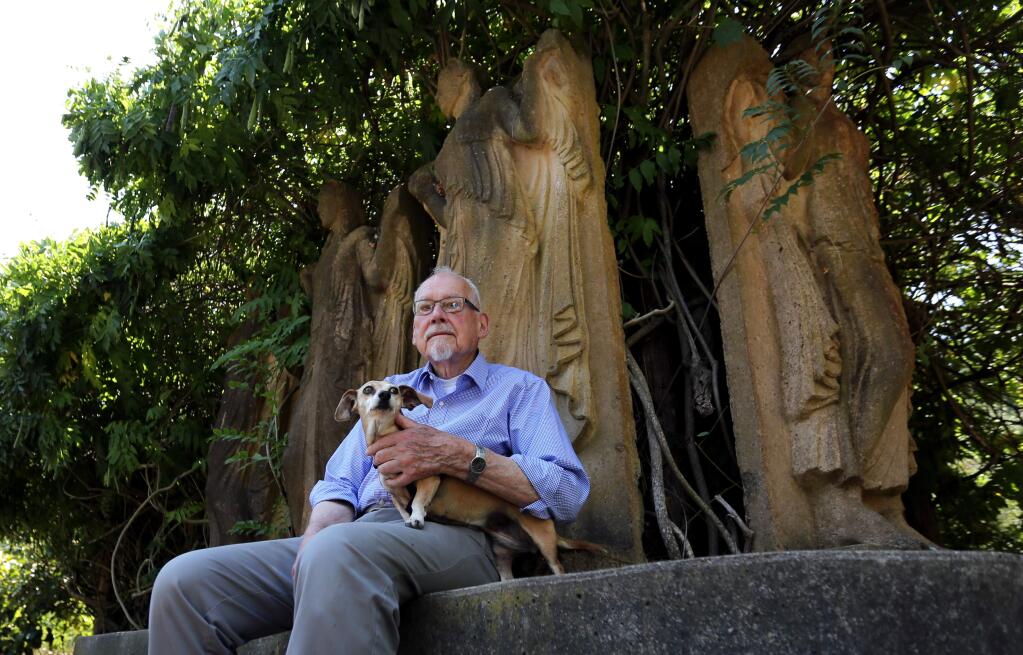 Jim Kidder with his dog Molly in his garden, which used to be a nursery, among statues that were extra molds from the Palace of Fine Arts that now reside at his home in Freestone, Thursday, August 6, 2015. In the 70's and 80's Kidder's Wishing Well Nursery was the popular spot to go in Freestone. (Crista Jeremiason / The Press Democrat)