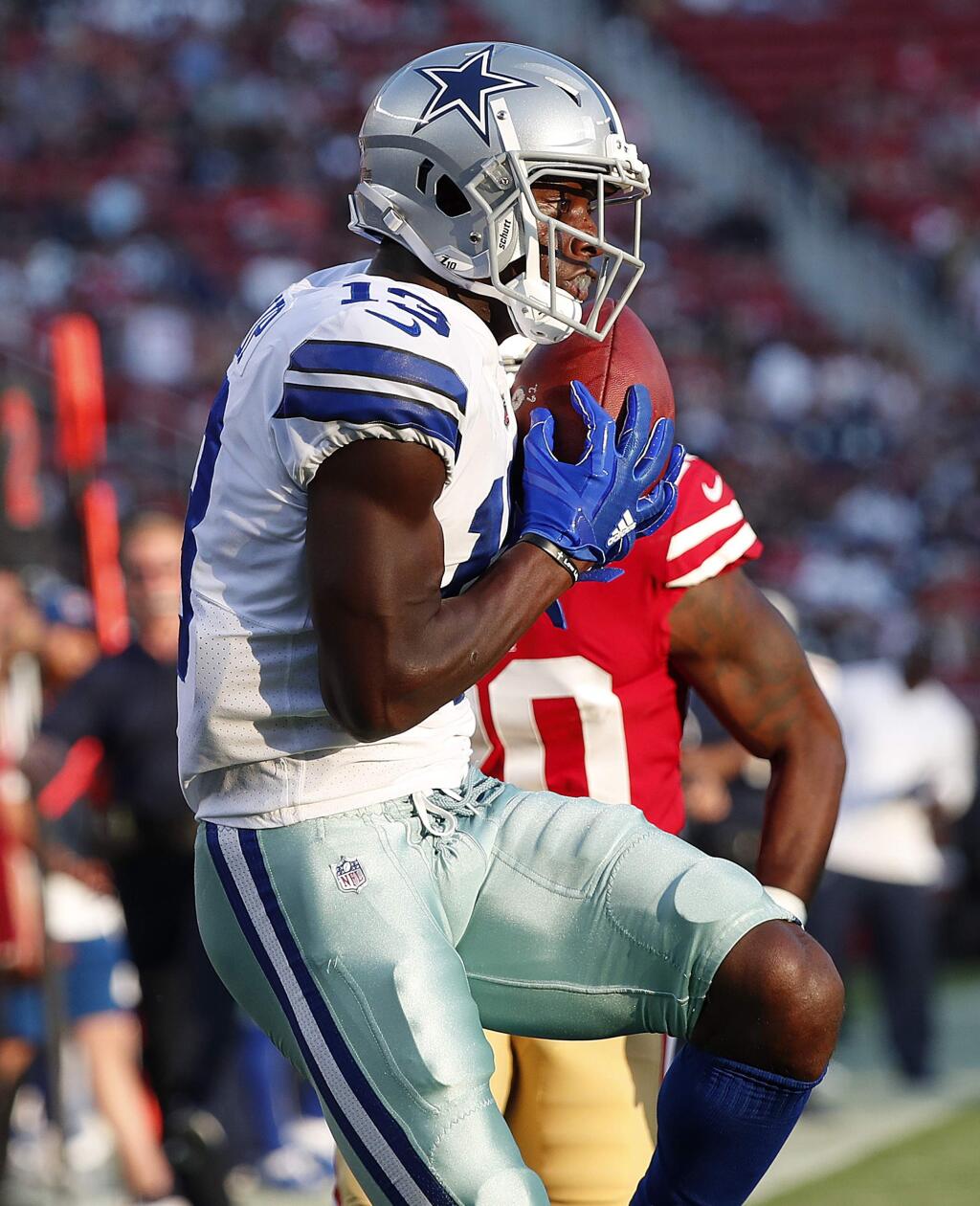 Dallas Cowboys wide receiver Michael Gallup, foreground, catches a touchdown pass in front of San Francisco 49ers defensive back Jimmie Ward during the first half of an NFL preseason football game in Santa Clara, Calif., Thursday, Aug. 9, 2018. (AP Photo/Tony Avelar)