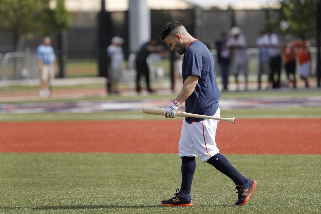 The Houston Astros' Jose Altuve carries a bat as he heads out to hit during spring training Thursday, Feb. 13, 2020, in West Palm Beach, Fla. (AP Photo/Jeff Roberson)