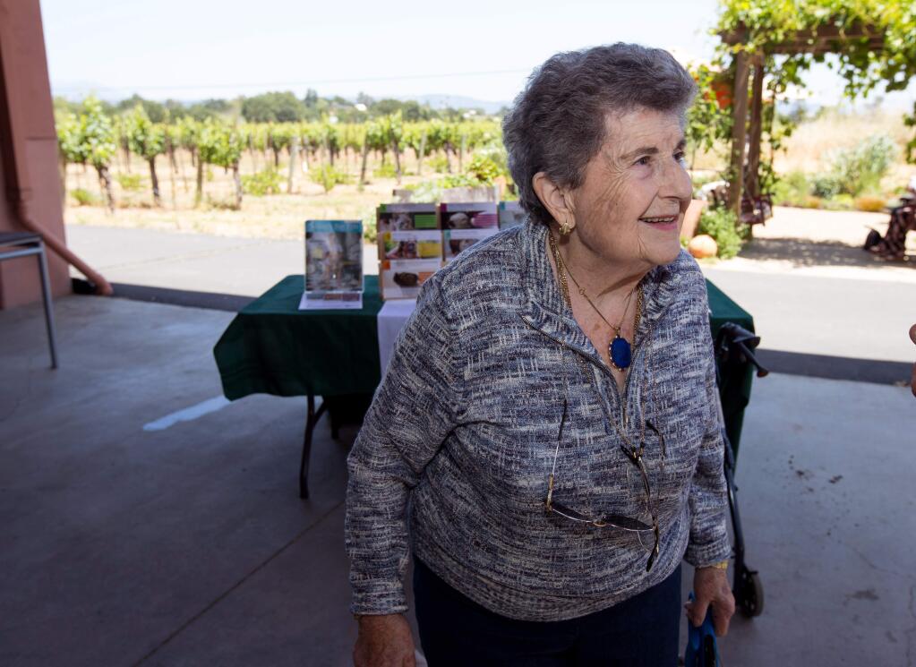 Pellegrini founder, Aida Pellegrini, 92, talks with people during the Puppies and Pinot fundraiser for Sonoma Humane Society held at Pellegrini Wine Co., in Santa Rosa, Calif., on Saturday, May 27, 2017. (Photo by Darryl Bush / For The Press Democrat)