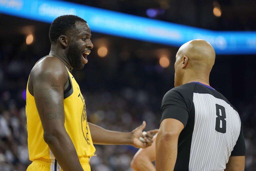 Golden State Warriors forward Draymond Green (23) argues with referee Marc Davis (8) during the first half against the Los Angeles Lakers, Tuesday, Dec. 25, 2018, in Oakland. (AP Photo/Tony Avelar)