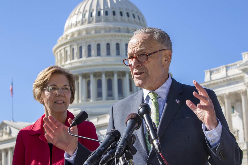 Sen. Elizabeth Warren, D-Mass., left, and Senate Minority Leader Chuck Schumer, D-N.Y., hold a news conference to criticize the Republican tax and budget proposals, at the Capitol in Washington, Wednesday, Oct. 18, 2017. (AP Photo/J. Scott Applewhite)