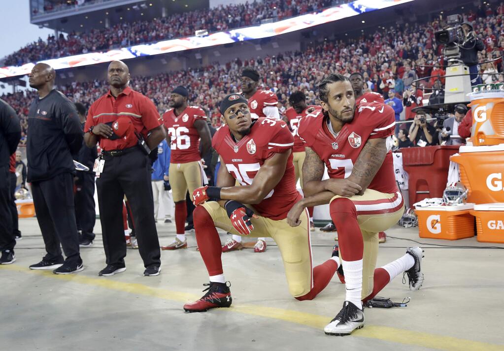In this Sept. 12, 2016, file photo, San Francisco 49ers safety Eric Reid (35) and quarterback Colin Kaepernick (7) kneel during the national anthem before a game against the Los Angeles Rams in Santa Clara. (AP Photo/Marcio Jose Sanchez, File)