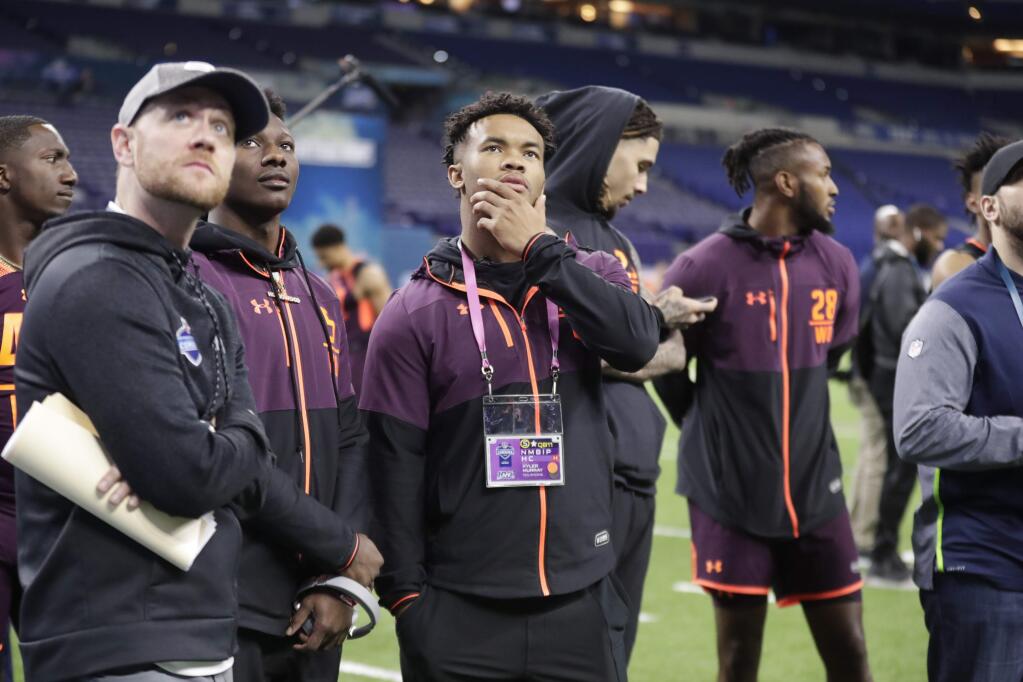 Oklahoma quarterback Kyler Murray, center, watches drills at the NFL scouting combine in Indianapolis, Saturday, March 2, 2019. (AP Photo/Michael Conroy)