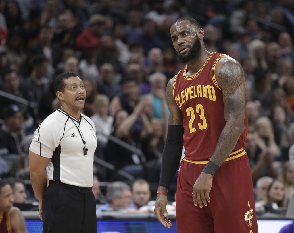 Cleveland Cavaliers forward LeBron James, right, reacts after being called for a technical foul by referee Bill Kennedy, left, during the first quarter of an NBA basketball game against the Sacramento Kings, Friday, Jan. 13, 2017, in Sacramento, Calif. (AP Photo/Rich Pedroncelli)