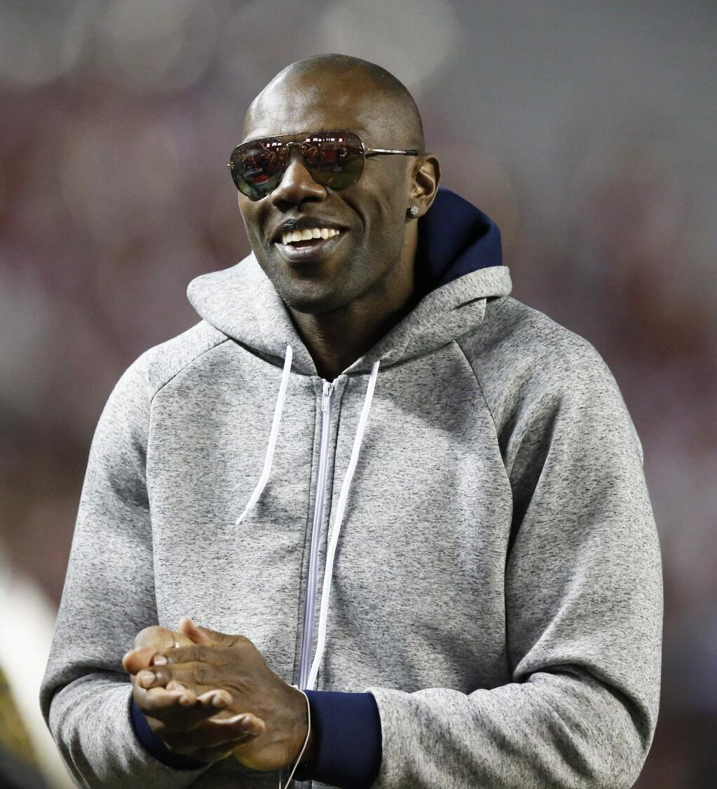 In this Nov. 19, 2016, file photo, former NFL wide receiver and Chattanooga alum Terrell Owens walks the sidelines during the second half of a game between Alabama and Chattanooga, in Tuscaloosa, Ala. Terrell Owens says he will not attend the induction ceremony for the Pro Football Hall of Fame in August, an unprecedented decision by an enshrinee. (AP Photo/Brynn Anderson, File)