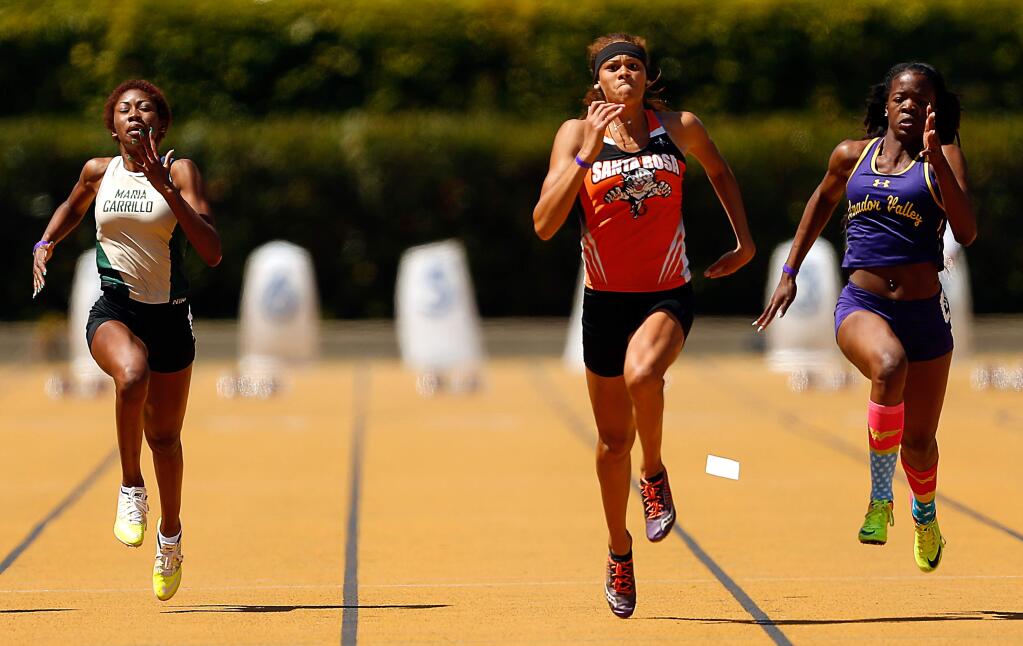 Santa Rosa's Kirsten Carter, center, sprints ahead of Maria Carrillo's Amani Baker, left, and Amador Valley's Chineyre Okoro, winning the girls 100-meter dash with a time of 11.89 seconds, during the NCS Meet of Champions at Edwards Stadium in Berkeley, California on Saturday, May 27, 2017. (Alvin Jornada / The Press Democrat)