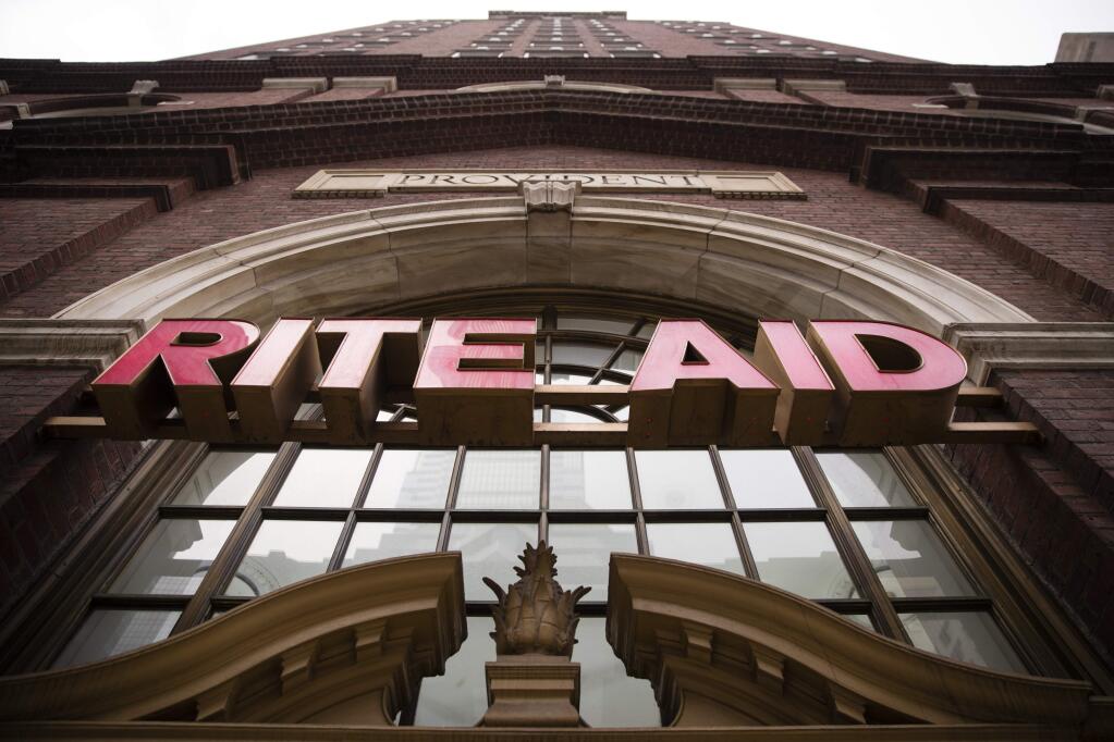 FILE - This Friday, Oct. 21, 2016, file photo, shows a Rite Aid location in Philadelphia. Walgreens ended its takeover pursuit of rival Rite Aid following resistance from U.S. regulators and will instead now buy stores, distribution centers and inventory in a new deal. (AP Photo/Matt Rourke, File)