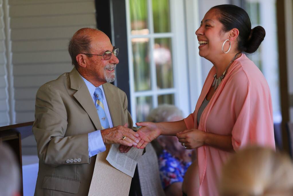 Jack DeMeo, left, introduces Elizabeth Quiroz as a scholarship recipient during the Valley of the Moon Children's Foundation Scholarship Awards Luncheon, in Santa Rosa, on Monday, July 25, 2016. (Christopher Chung/ The Press Democrat)