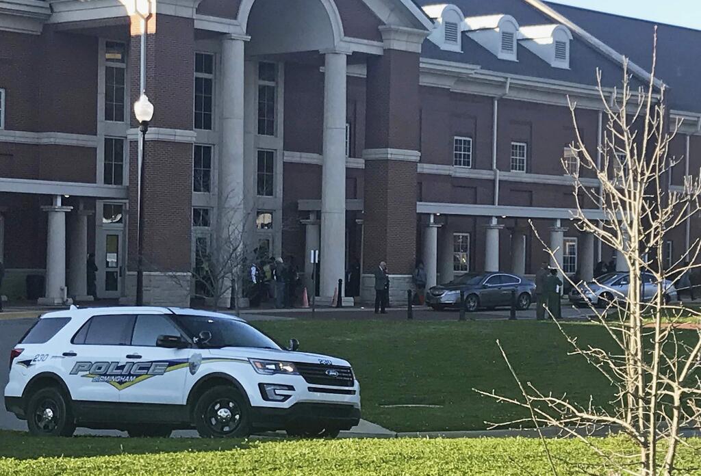 Authorities investigate the scene where a shooting occurred at Huffman High School, Wednesday, March 7, 2018, in Birmingham, Ala. (Carol Robinson/AL.com via AP)