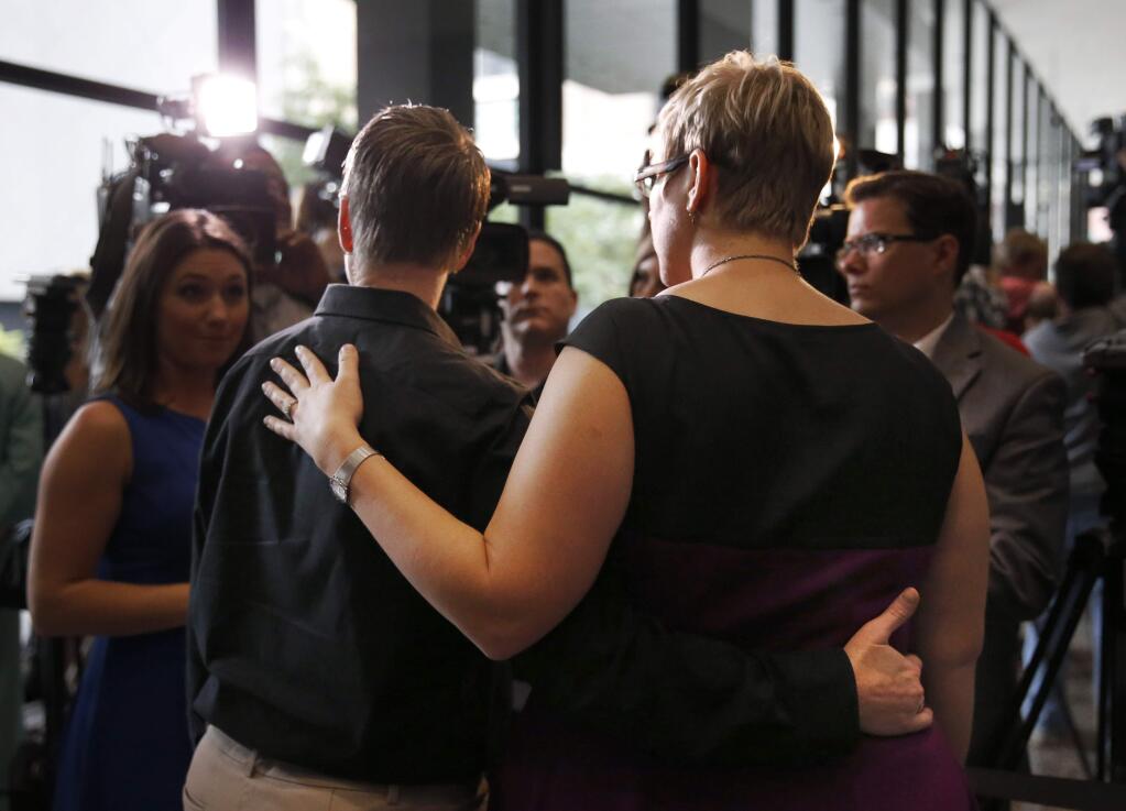 Tara Betterman-Layne, left, and her wife Melody Betterman-Layne, both from Indianapolis, Ind., talk to reporters after attending a hearing before the 7th U.S. Circuit Court of Appeals on the challenges to Indiana and Wisconsin's gay marriage ban Tuesday, Aug. 26, 2014, in Chicago. (AP Photo/Charles Rex Arbogast)