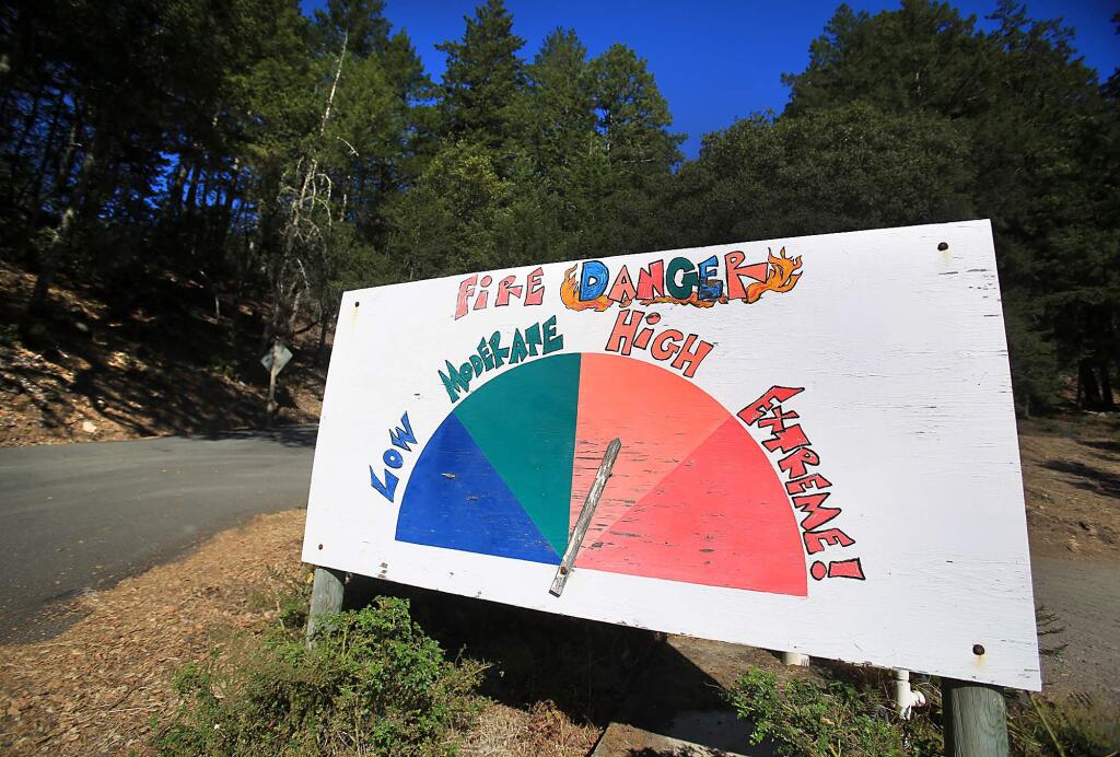 At the Mayacmas Volunteer Fire Department, Friday Sept. 11, 2015, a larger-than-life fire danger warning greets drivers traveling over Trinity Grade. (Kent Porter / Press Democrat)