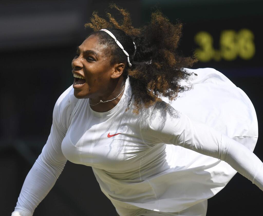 Serena Williams of the US serves to Julia Goerges of Germany during their women's semifinal match at the Wimbledon Tennis Championships in London, Thursday July 12, 2018. (Neil Hall/Pool via AP)
