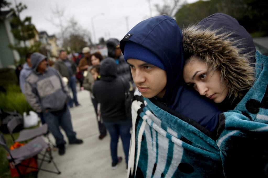 Julio Quinonez and his fiancee Michelle Ramirez wait in line to apply for the new Tierra Springs Apartments, for moderate and middle income households, at Terracina at Santa Rosa apartment complex in Santa Rosa, California on Wednesday, February 18, 2015. (BETH SCHLANKER/ The Press Democrat)