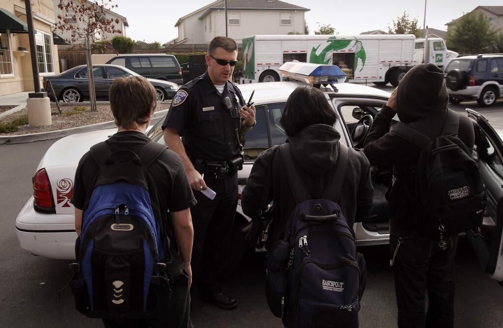 (File photo) Waid Allred, school resource officer with the Santa Rosa Police Department, talks to Elsie Allen High students he spotted off-campus when he already had three students in his car to take back to school. After calling the campus, he gave these three 10 minutes to walk back to school. (PRESS DEMOCRAT/ MARK ARONOFF)