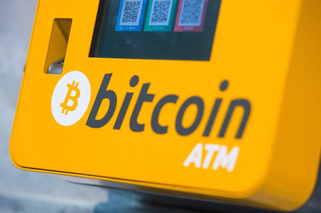File - This is a Oct. 16, 2015 file photo of a Bitcoin ATM. An Australian man long thought to be associated with the digital currency Bitcoin has publicly identified himself as its creator. BBC News said Monday, May 2, 2016 that Craig Wright told the media outlet he is the man previously known by the pseudonym Satoshi Nakamoto. The computer scientist, inventor and academic says he launched the currency in 2009 with the help of others. (Dominic Lipinski/PA via AP, File) UNITED KINGDOM OUT NO SALES NO ARCHIVE