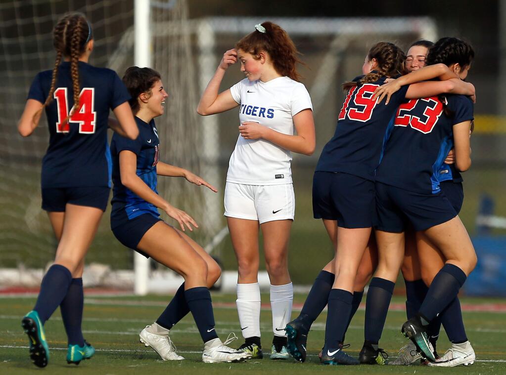 Analy's Isabella Gilbraith, center, appears disappointed as the Campolindo Cougars celebrate their second goal of the game, in the 20th minute of the second half, during the NCS Division 3 girls varsity soccer championship match in Rohnert Park on Saturday, February 24, 2018. (Alvin Jornada / The Press Democrat)