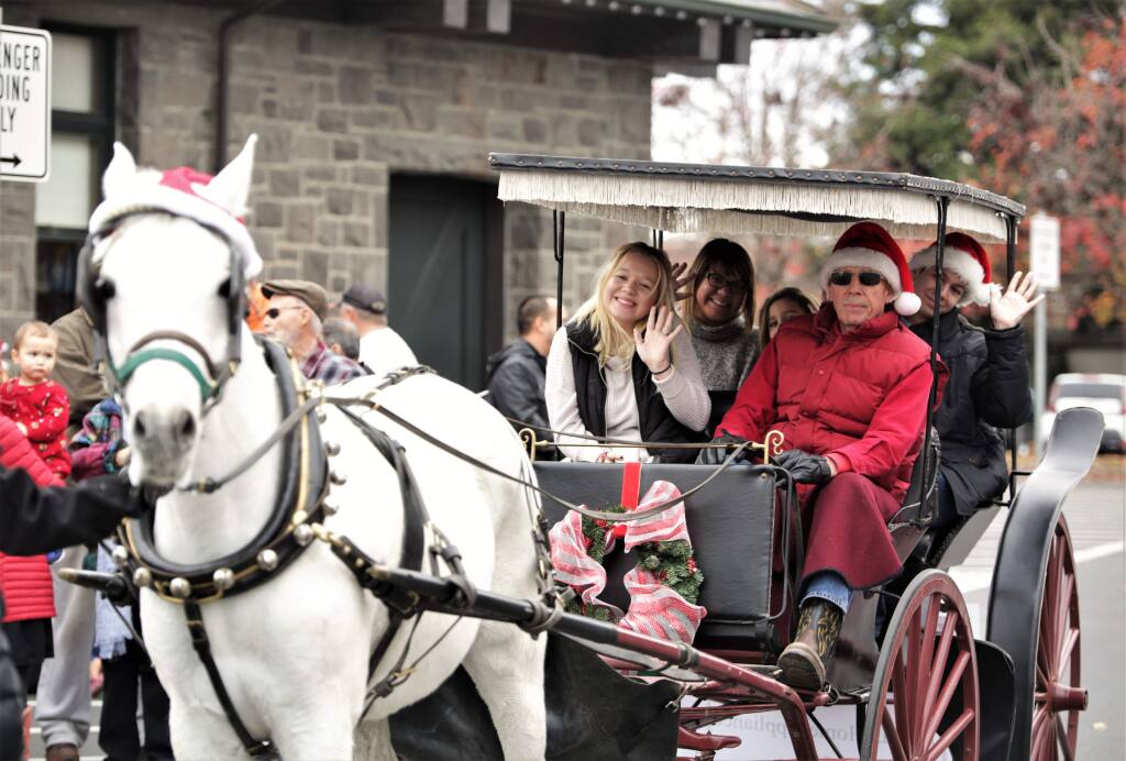 Families enjoyed holiday horse and carriage rides in historic Railroad Square in Santa Rosa, Sunday December 24th, 2017. (photo Will Bucquoy/for the Press Democrat).