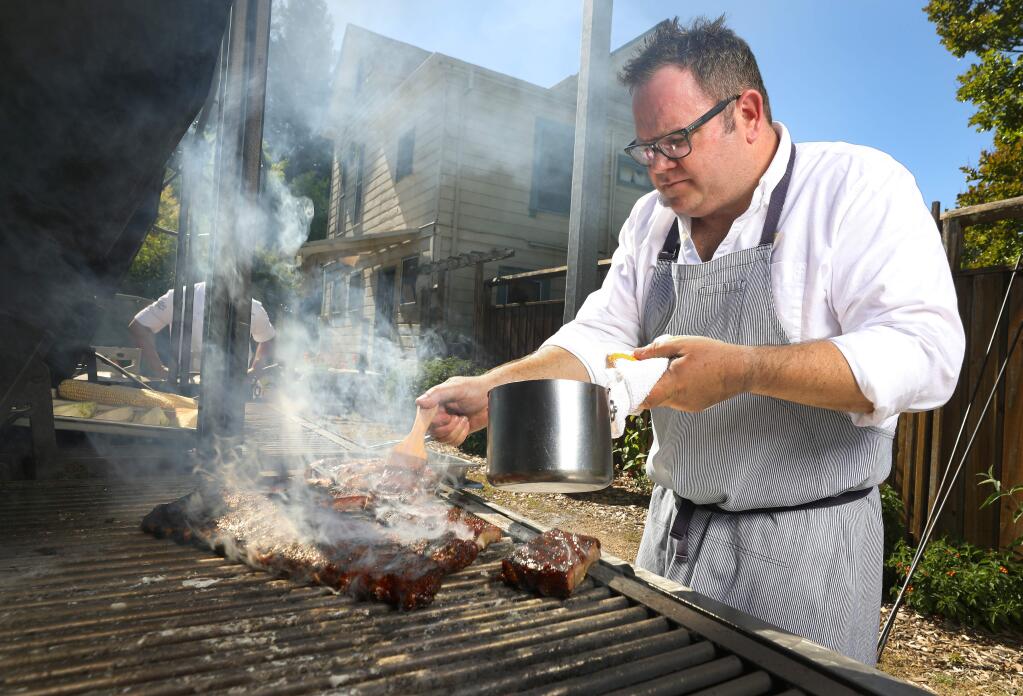 Seghesio Family Vineyards executive chef Peter Janiak brushes St. Louis cut ribs with the Seghesio Kitchen Zinfandel BBQ Sauce.