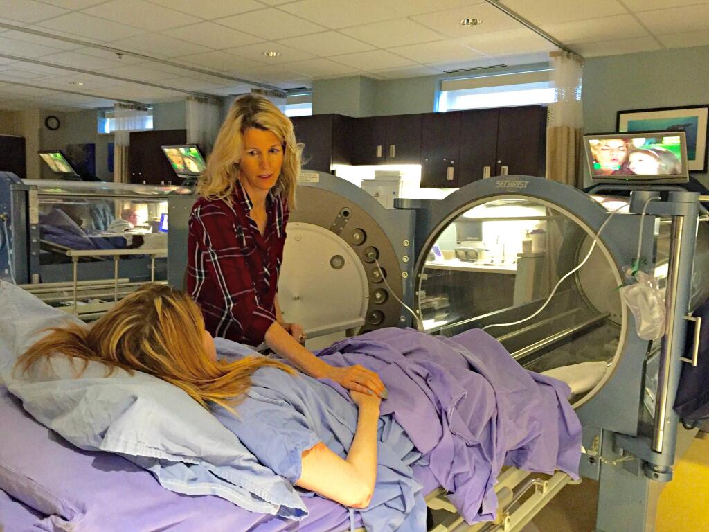 Margrett Lewis speaks to her daughter Nicolette before a session in a hyperbaric chamber in a Maryland hospital on June 1.