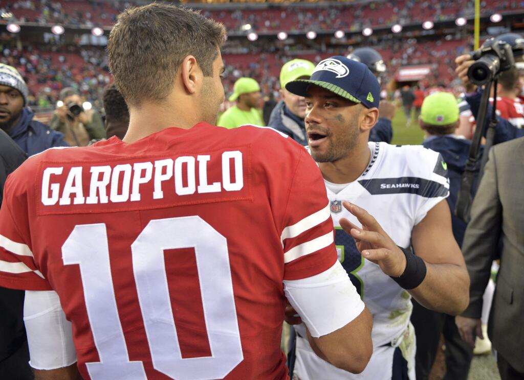 San Francisco 49ers quarterback Jimmy Garoppolo (10) shakes hands with Seattle Seahawks quarterback Russell Wilson at the end of an NFL football game Sunday, Nov. 26, 2017, in Santa Clara, Calif. (AP Photo/Don Feria)