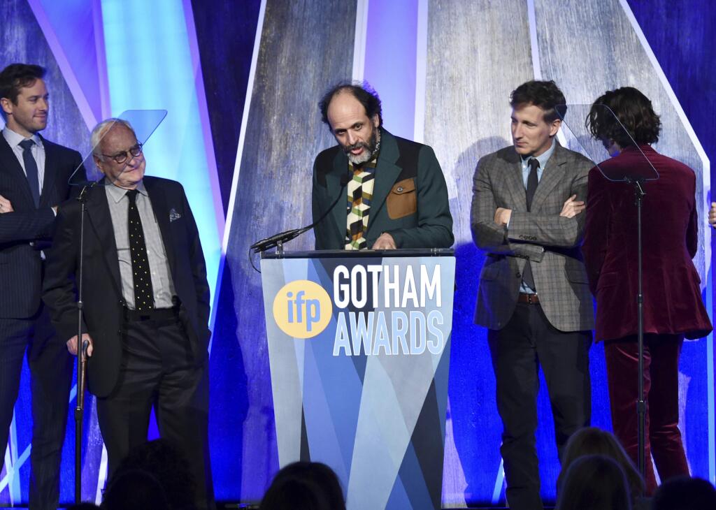 FILE - In this Nov. 27, 2017, file photo, director Luca Guadagnino, center, accepts the best feature award for 'Call Me By Your Name' at the 27th annual Independent Film Project's Gotham Awards at Cipriani Wall Street in New York. The Los Angeles Film Critics Association announced Sunday, Dec. 3, on Twitter that it has voted 'Call Me By Your Name' the best film of the year, bestowing a total of three awards on Guadagnino's erotic coming-of-age tale. (Photo by Evan Agostini/Invision/AP, File)