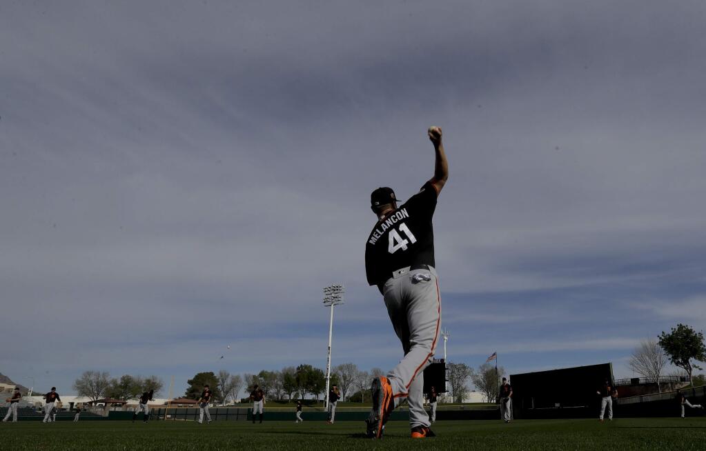 San Francisco Giants relief pitcher Mark Melancon warms up during spring baseball practice in Scottsdale, Ariz., Tuesday, Feb. 14, 2017. (AP Photo/Chris Carlson)