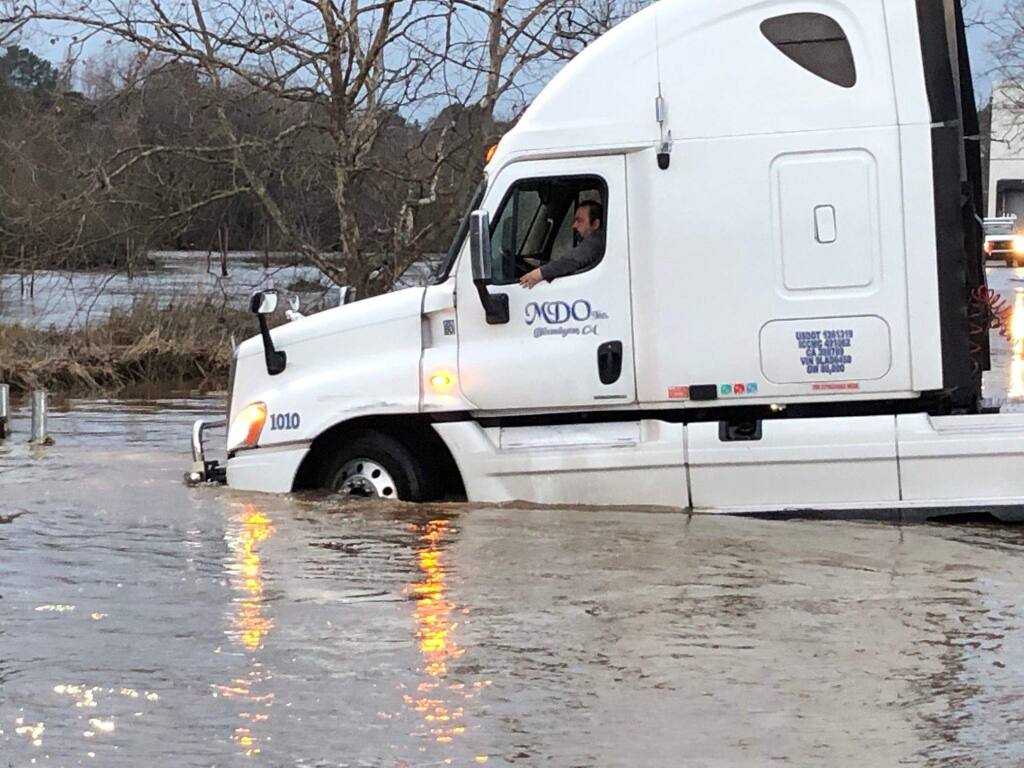 A truck navigates high water from the flooded Petaluma River behind Industrial Avenue in Petaluma on Jan. 17, 2019. MATT BROWN/ARGUS-COURIER STAFF