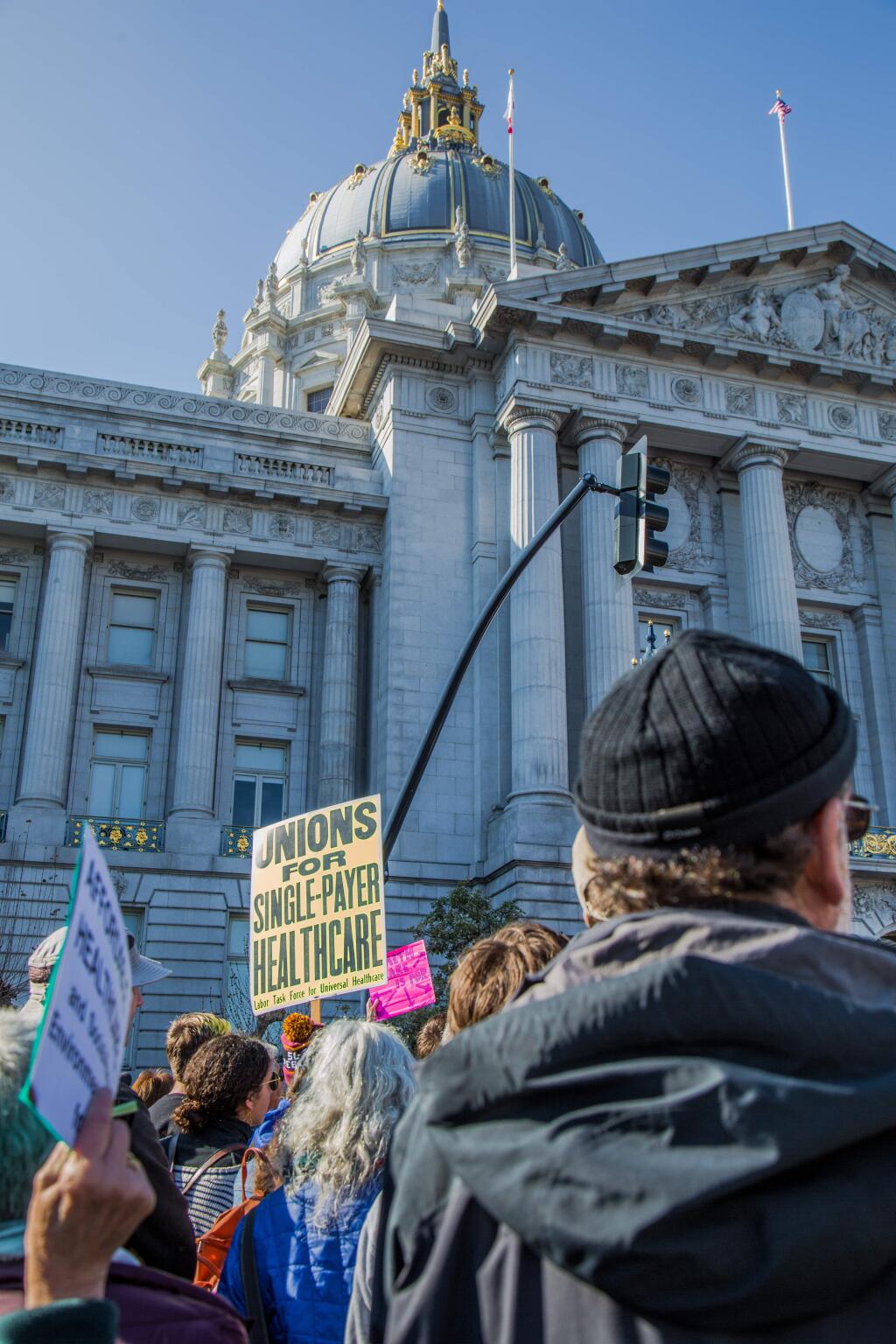 A person holds a sign during a healthcare rally held in front of city hall in downtown San Francisco January 15, 2017. (Shutterstock.com)