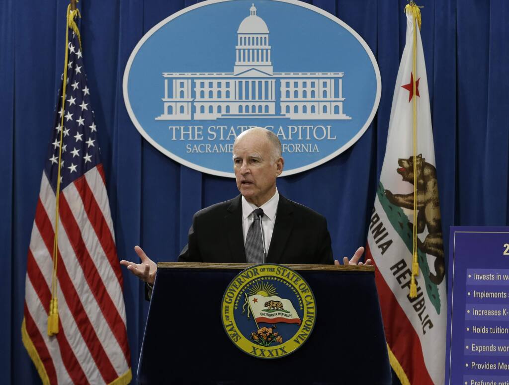 California Gov. Jerry Brown gestures as he discusses his proposed 2015-16 state budget plan at a Capitol news conference in Sacramento, Calif., Friday, Jan. 9, 2015. Brown on Friday released a record $113 billion state spending plan that asks the University of California to do more with less so the nation's largest public university system can avert tuition hikes. (AP Photo/Rich Pedroncelli)