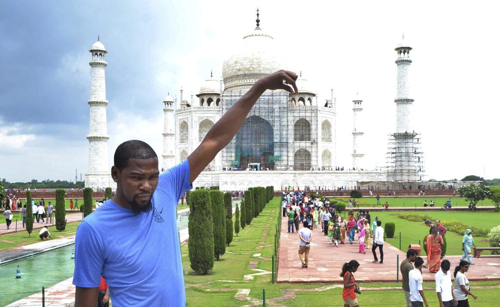 Kevin Durant poses in front of the Taj Mahal in Agra, India, Saturday, July 29, 2017. Durant is in India to support the continued growth of basketball in the country and meet the elite prospects of NBA Academy India. (AP Photo/Pawan Sharma)