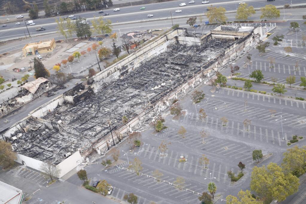 Only charred rubble remains of the interior of the K-Mart store scorched by the Tubbs fire in Santa Rosa as seen in this aerial photograph taken from a Cal Fire helicopter, Thursday Oct. 19, 2017. (Will Bucquoy / For The Press Democrat)