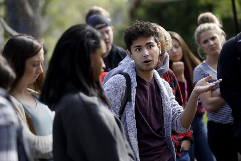 Student Mark Murakami questions SRJC President Frank Chong about the possible cuts to summer course offerings outside Bailey Hall on the campus of the Santa Rosa Junior College in Santa Rosa, on Monday, April 2, 2018. (BETH SCHLANKER/ The Press Democrat)