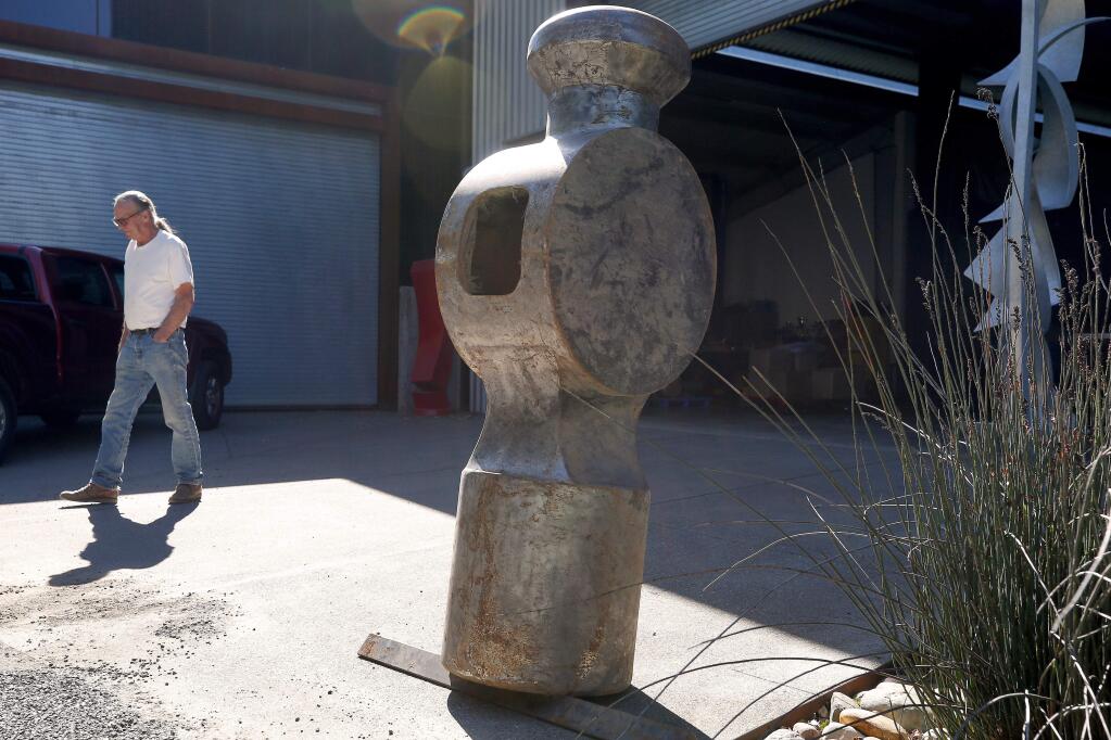 Artist Doug Unkrey, creator of the 800-pound hammer sculpture, stands beside the hammer head after its return to his studio at the Voigt Family Sculpture Foundation in Healdsburg, California, on Friday, April 12, 2019. 'The Hammer' sculpture was stolen in October 2018 from its installation at the Healdsburg Community Center. (Alvin Jornada / The Press Democrat)