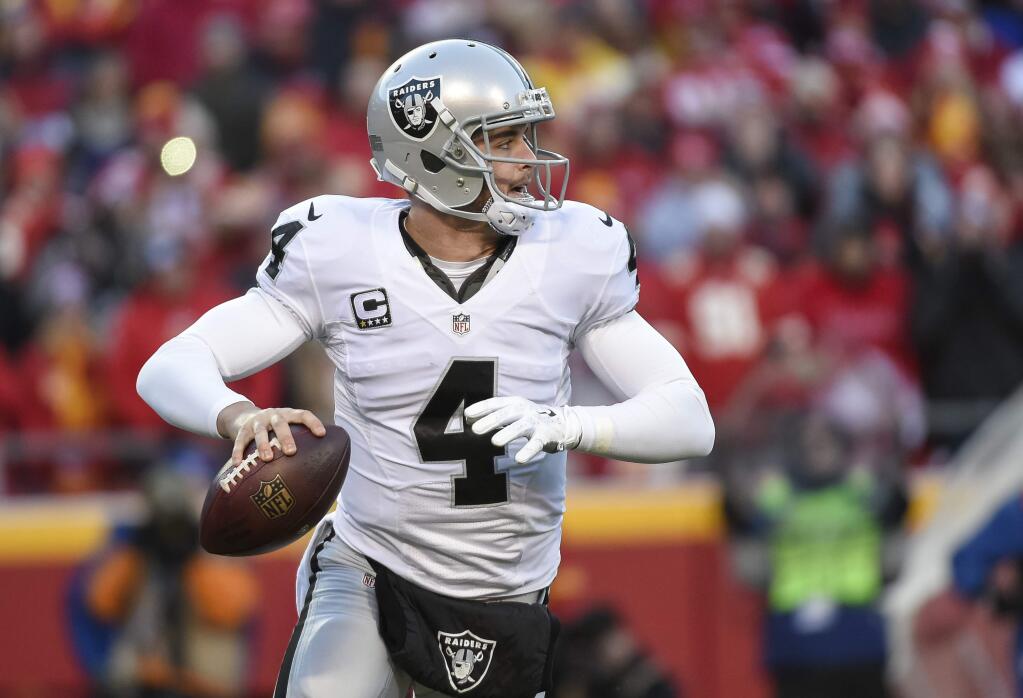 Oakland Raiders quarterback Derek Carr (4) looks to throw against the Kansas City Chiefs during the first half of their NFL football game in Kansas City, Mo., Sunday, Jan, 3, 2016. (AP Photo/Reed Hoffmann)
