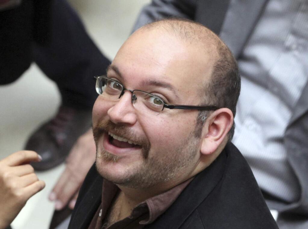 FILE - In this photo April 11, 2013 file photo, Jason Rezaian, an Iranian-American correspondent for the Washington Post, smiles as he attends a presidential campaign of President Hassan Rouhani, in Tehran, Iran. The closed trial of Rezaian detained in Iran for more than 10 months has begun in a court used to hear security cases. Iran's official IRNA news agency says the trial of Rezaian began Tuesday, May 26, 2015 in a Revolutionary Court, saying he has been charged with espionage and propaganda against the Islamic republic. (AP Photo/Vahid Salemi, File)