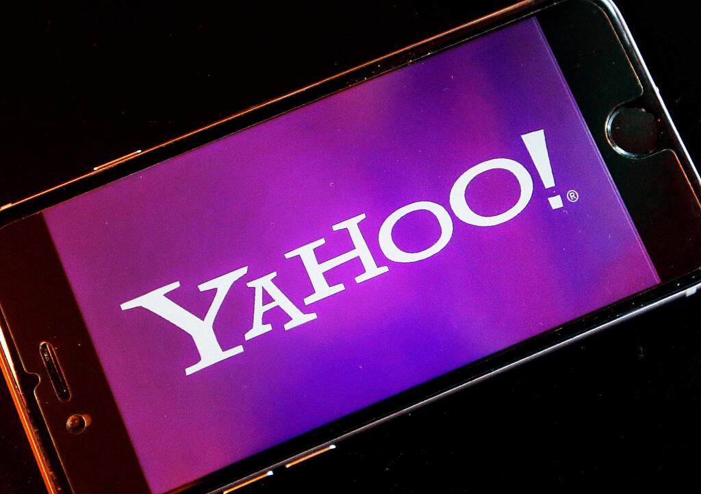 FILE - In this Dec. 15, 2016, file photo, the Yahoo logo appears on a smartphone in Frankfurt, Germany. The company formerly known as Yahoo is paying a $35 million fine to resolve federal regulators' charges that the online pioneer deceived investors by failing to disclose one of the biggest data breaches in internet history. The Securities and Exchange Commission announced the action Tuesday, April 24, 2018, against the company, which is now called Altaba after its most valuable parts were sold to Verizon Communications for $4.48 billion last year.. (AP Photo/Michael Probst, File)
