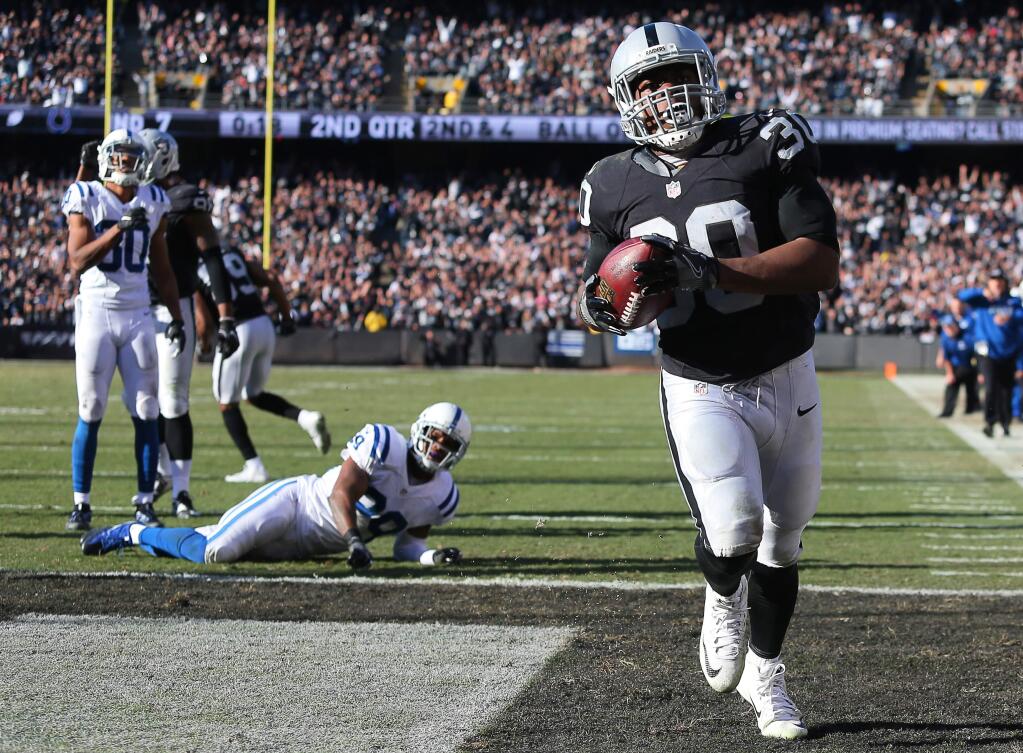 Oakland Raiders running back Jalen Richard scores a touchdown against the Indianapolis Colts, during their game in Oakland on Saturday, Dec. 24. The Raiders defeated the Colts 33-25. (Christopher Chung / The Press Democrat)