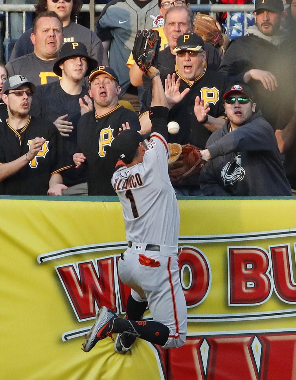 San Francisco Giants left fielder Gregor Blanco (1) leaps for but cannot come up with a two-run home run by Pittsburgh Pirates' Starling Marte in the first inning of a baseball game in Pittsburgh, Friday, May 11, 2018. (AP Photo/Gene J. Puskar)