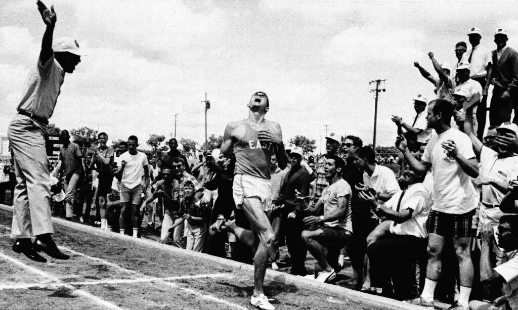Jim Ryun, then a senior at Wichita High School, breaks the tape in running a mile in 3 minutes, 58.3 second at a high school track meet in Kansas on May 15, 1965. (AP Photo)
